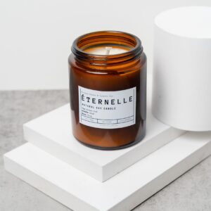 Front view of the Eternelle candle with amber‑oud‑musk‑rose label in a 150ml jar.