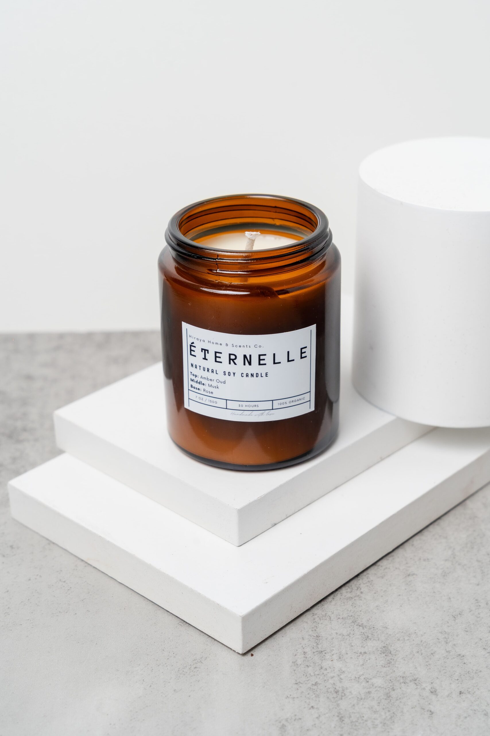 Front view of the Eternelle candle with amber‑oud‑musk‑rose label in a 150ml jar.