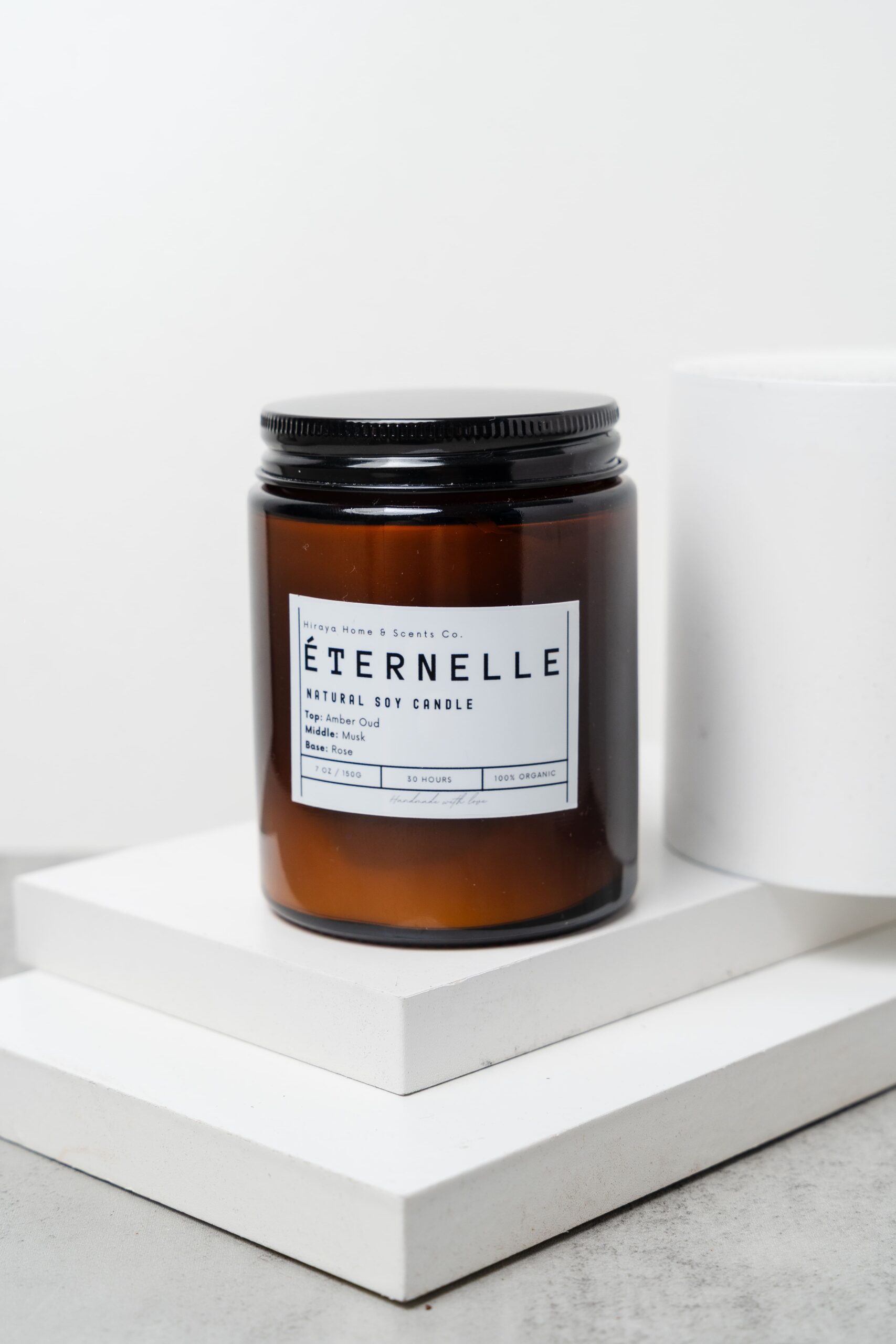 Close‑up showing wax texture and luxurious rose‑amber label details.