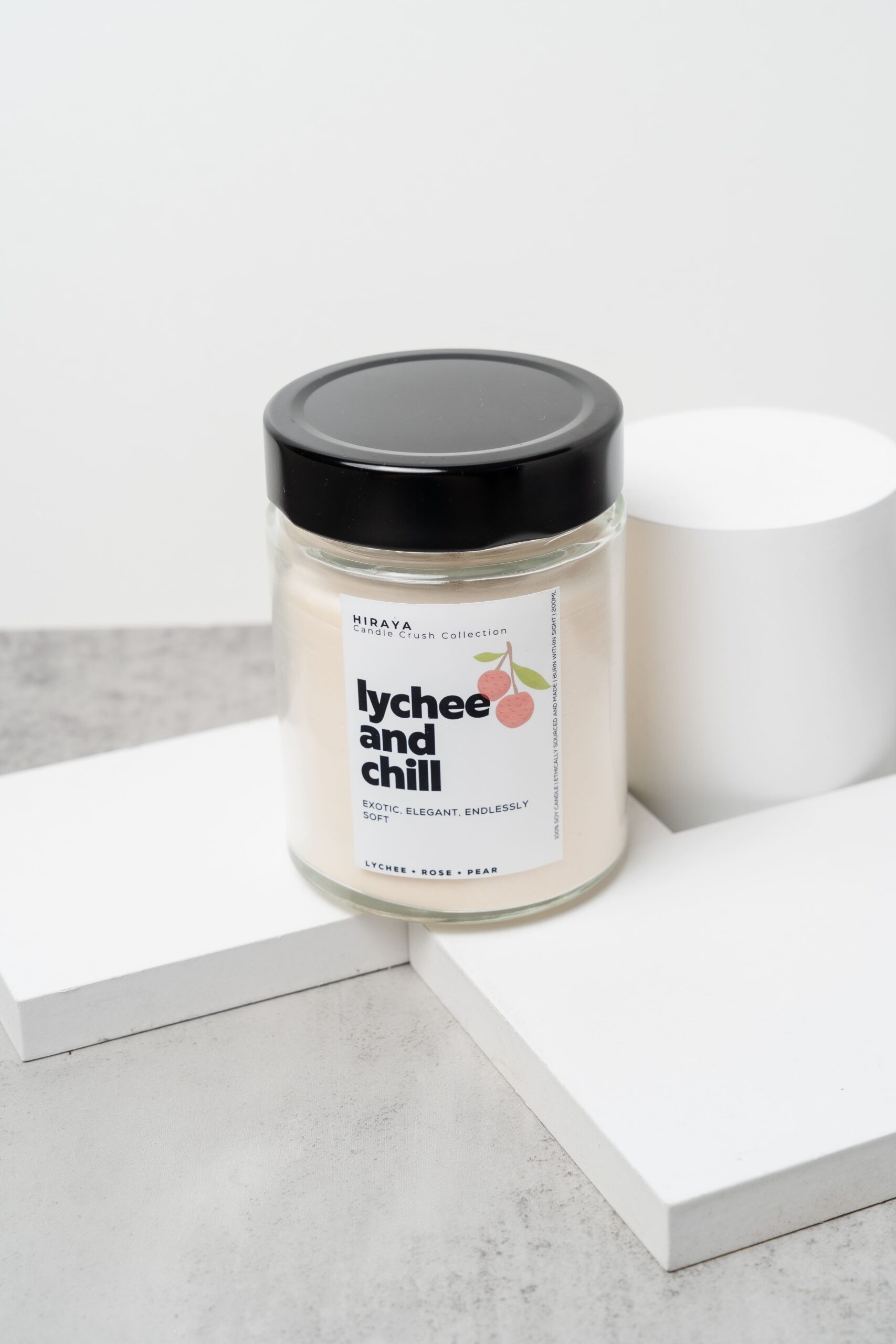 Front view of the Lychee and Chill candle with its soft, elegant lychee‑rose label in a 280ml jar.