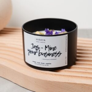 Front view of the Jas‑Mine Your Business candle with its amber‑oud‑jasmine label in a 220ml jar, styled in a soft, feminine aesthetic.