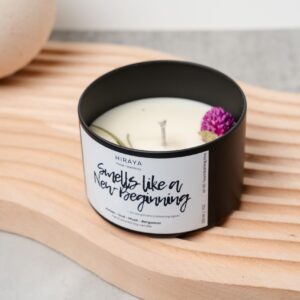 Front view of the Smells Like New Beginning candle with its amber‑oud‑bergamot label in a 220ml jar, styled in a clean, modern aesthetic.