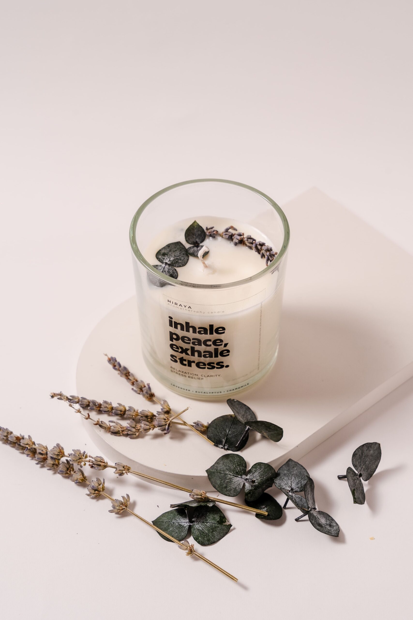 op view of calming lavender, eucalyptus, and chamomile candle showing dried floral toppings
