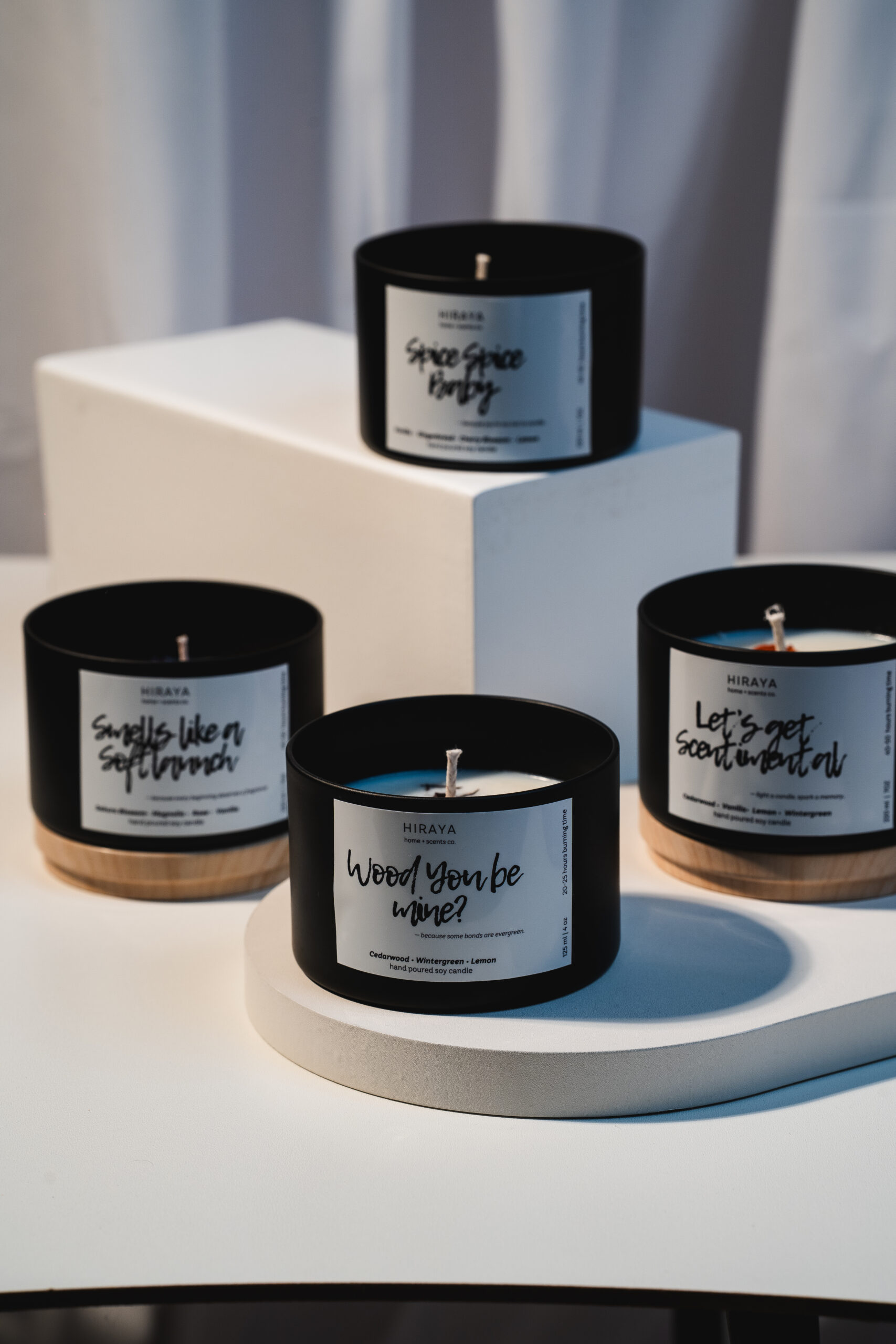 Lifestyle image of the full Floral Collection soy candles arranged with flowers for a gentle, romantic mood